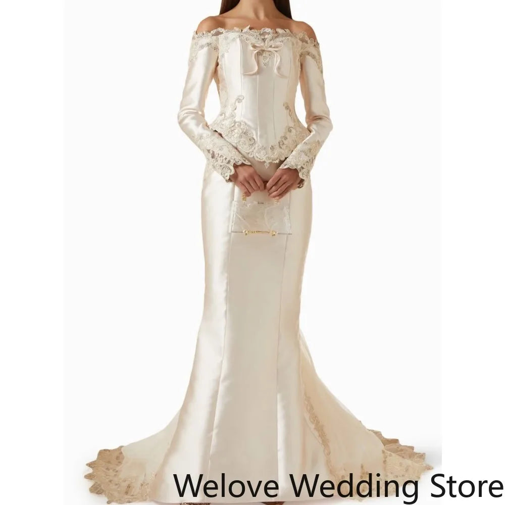 Ivory Victorian‑Style Bridal Wedding Gown with Off‑Shoulder Neckline, Long Sleeves, Structured Corset Bodice with Front Bow